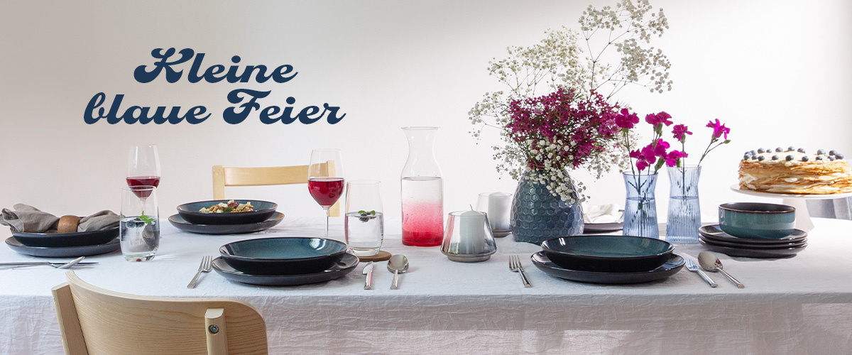 Blue table setting with wooden accessories