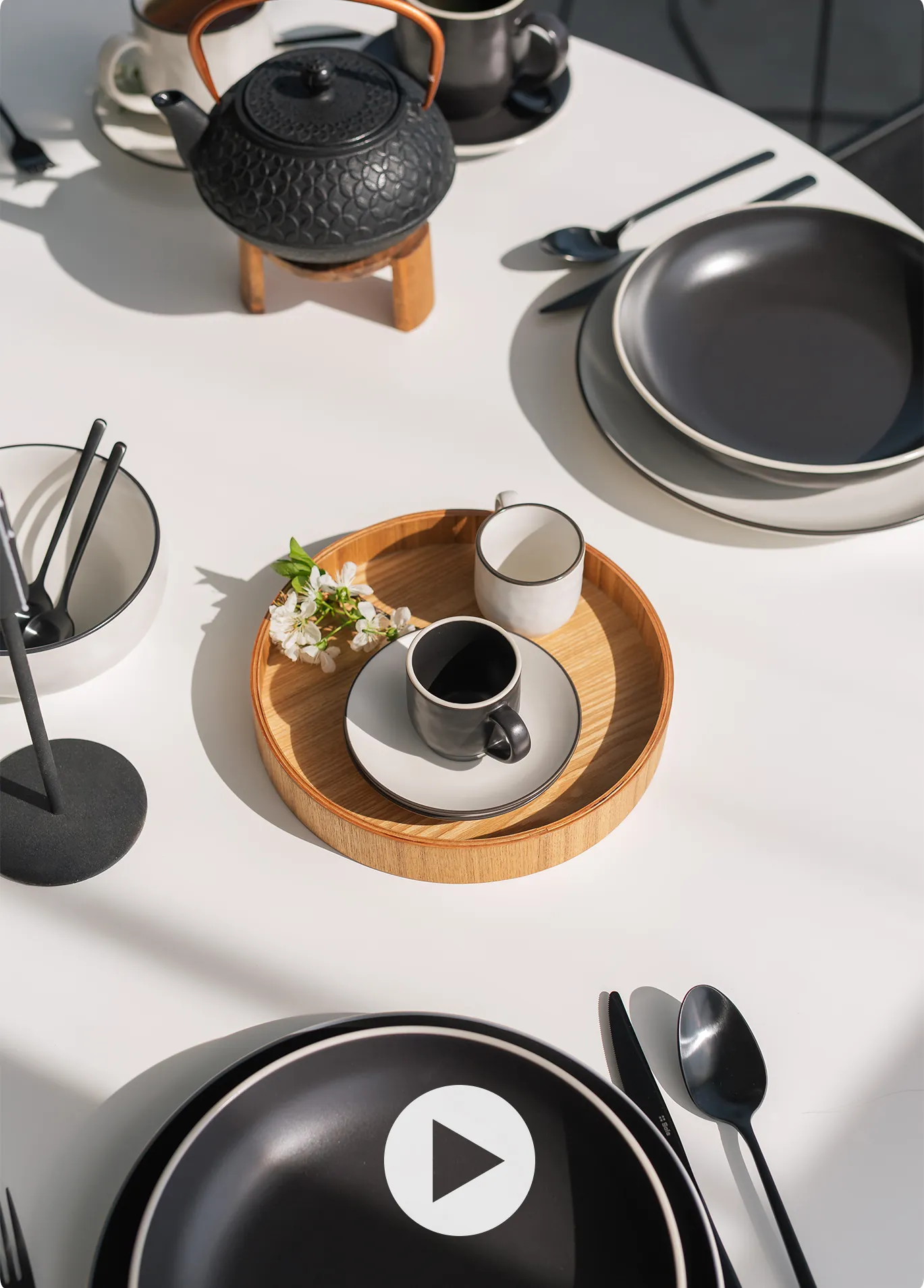 Set table with a black teapot and black-and-white tableware